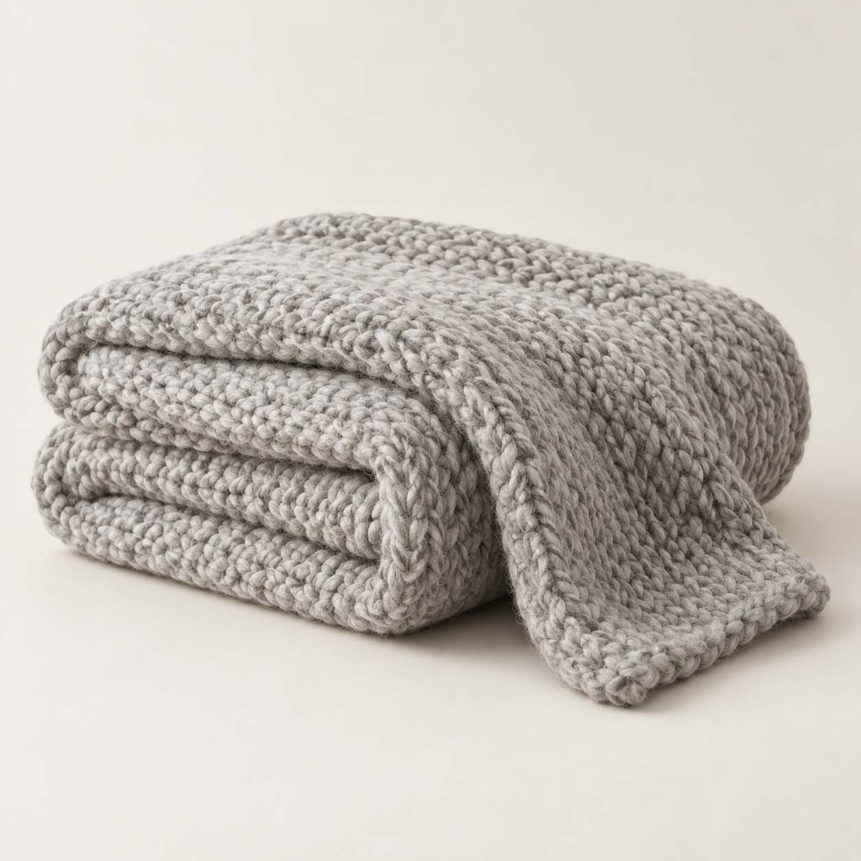 Wool Throw - product card from your Shopify store Folded grey chunky-knit wool throw